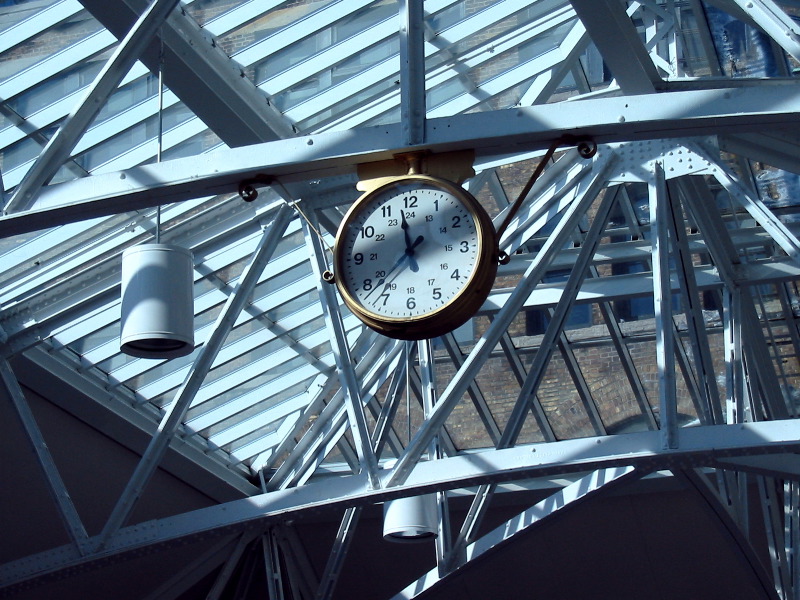 L'horloge entourée de la maçonnerie de fer de la verrière.